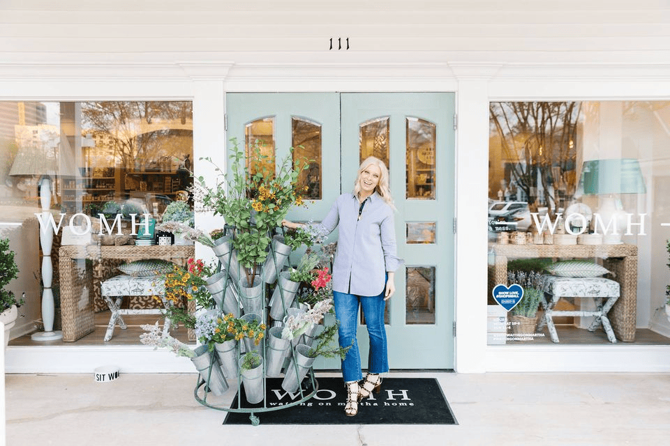 photo of waiting on martha home storefront with the owner of the store in the photo, one of the best places for shopping in Atlanta