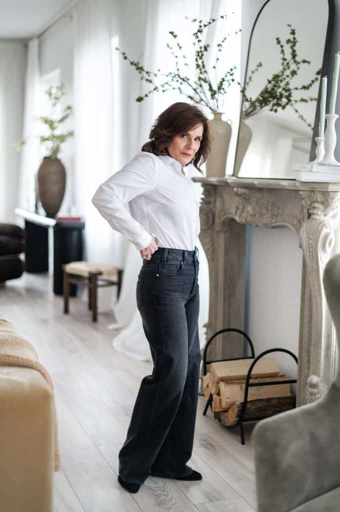 Beth demonstrating proper waist and rise placement on high rise jeans for a petite frame.