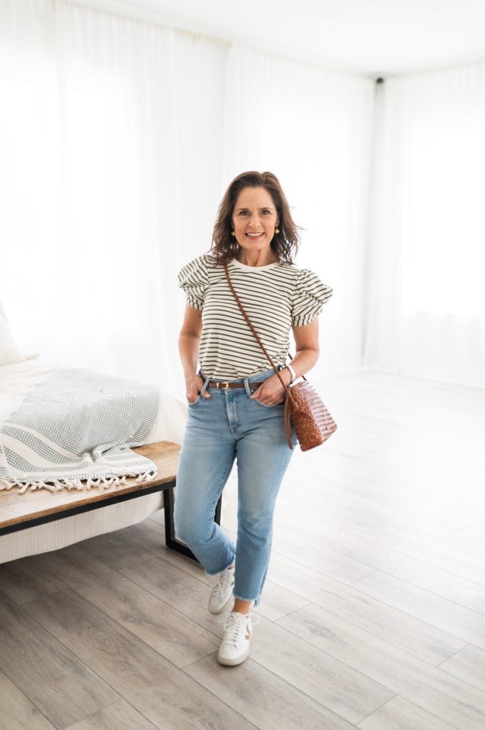 Beth wearing cropped jeans in a warm-weather outfit with sneakers, styled to hit at the ankle for a petite frame.