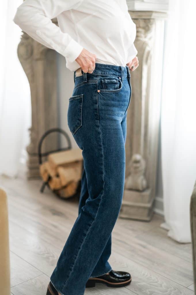 Example of proper rise fit on petite jeans showing where the waistband should sit.