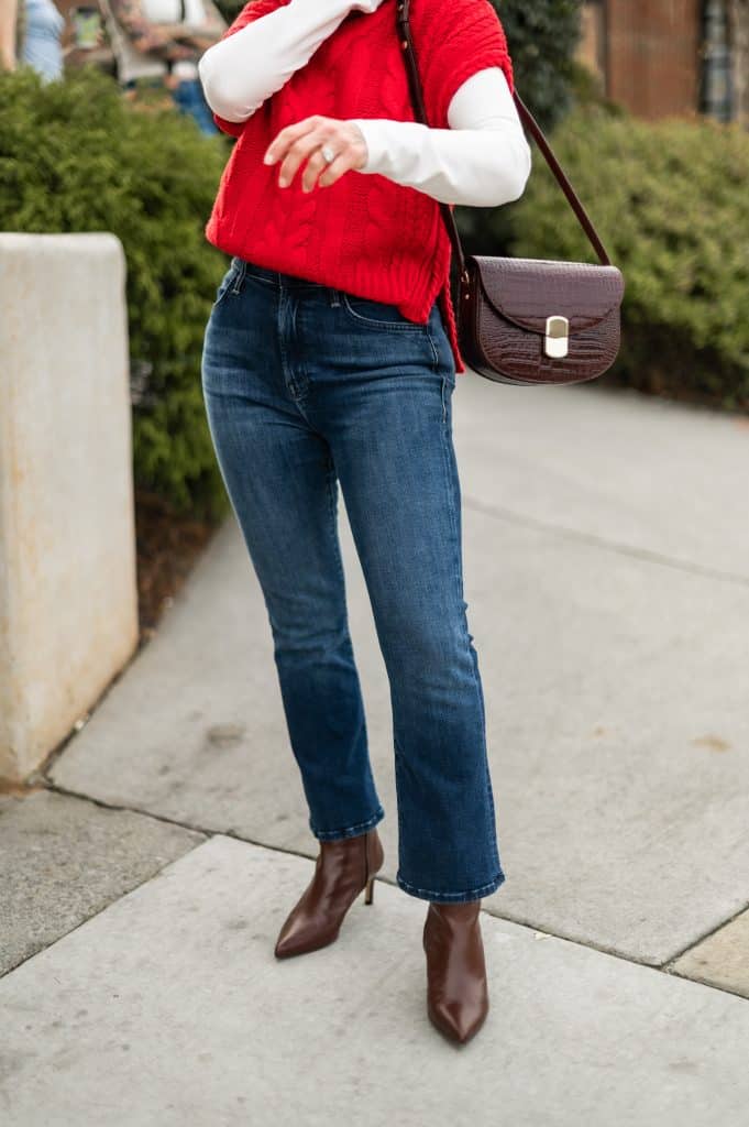 Close-up of cropped jeans with heeled ankle boots showing winter-appropriate hem length on a petite frame.