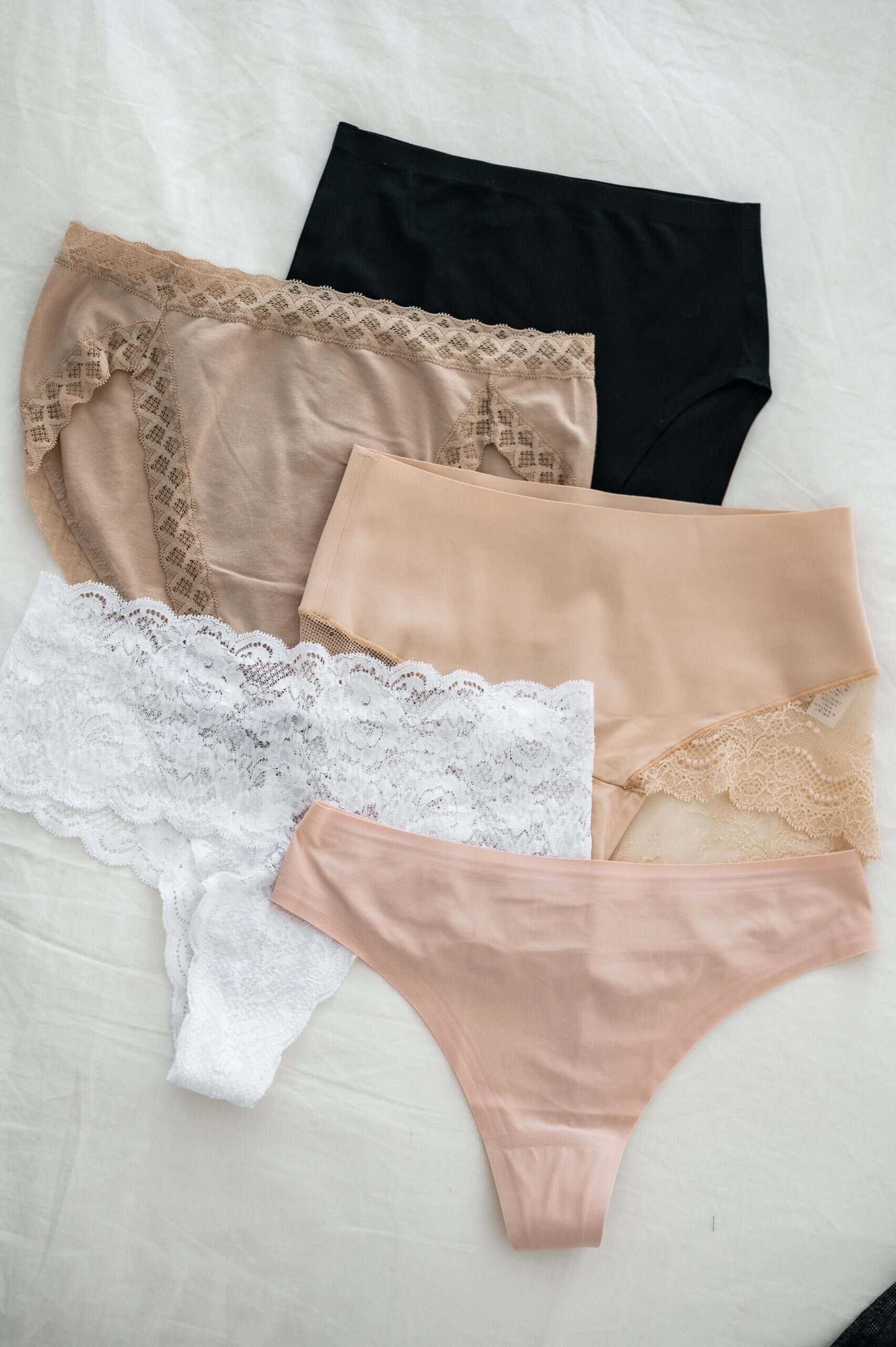 Five of my favorite underwear styles for women over 50, including seamless, cotton, lace, and thong styles for different outfits.